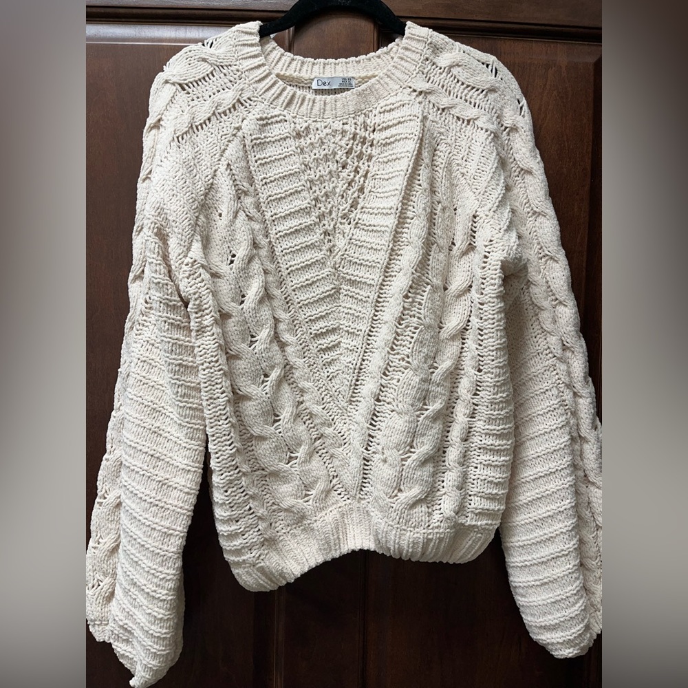 Dex cable knit sweater with oversized sleeves.